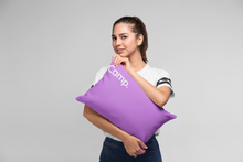 girl holding purple camp pillow