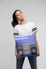 Girl holding a blue throw pillow cover with a boombox design