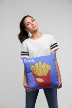 girl holding a blue throw pillow in blue with a french fries design